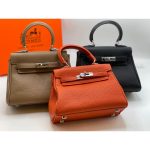 HERMES KELLY TOGO 25 RETURNS ORANGE HANDBAG.